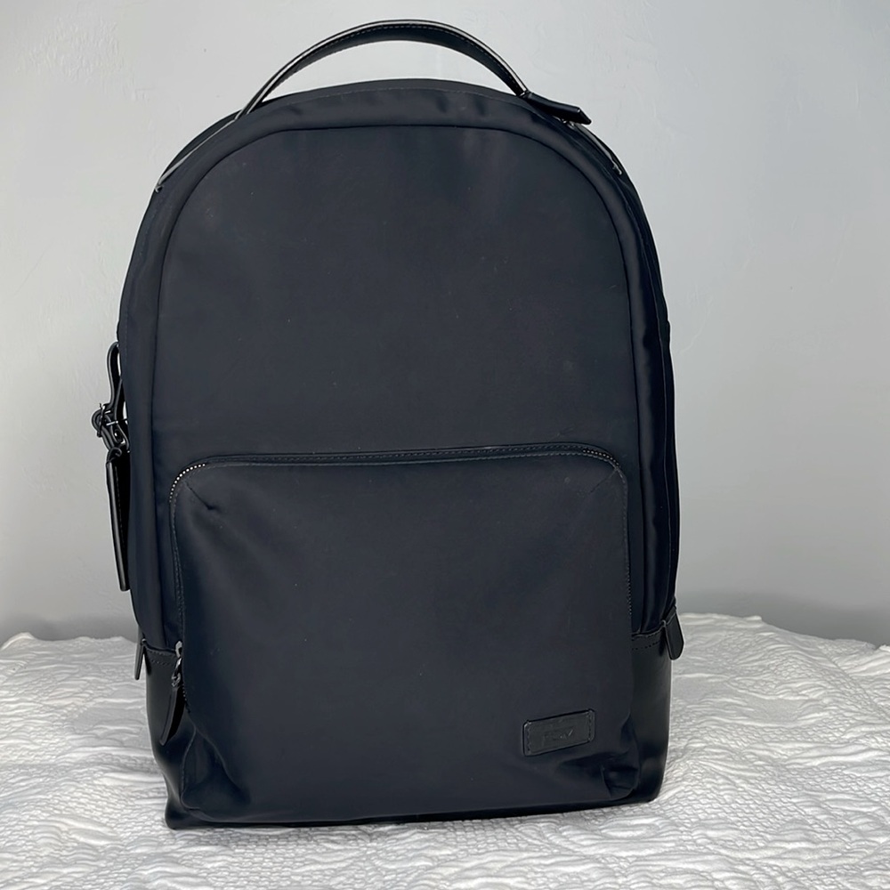 TUMI  RETIRED Wilson black backpack nylon with leather accents and bottom.